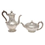 A VICTORIAN SILVER TEA POT & MATCHING COFFEE POT.