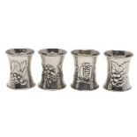 A SET OF FOUR EDWARDIAN ARTS & CRAFTS SILVER NAPKIN RINGS, BY OMAR RAMSDEN & ALWYN CARR.