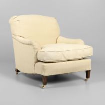 A HOWARD-STYLE DEEP SEATED ARMCHAIR.