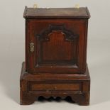 A 17TH CENTURY OAK SPICE CUPBOARD.