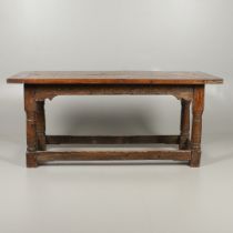 A 17TH CENTURY AND LATER OAK REFECTORY TABLE.