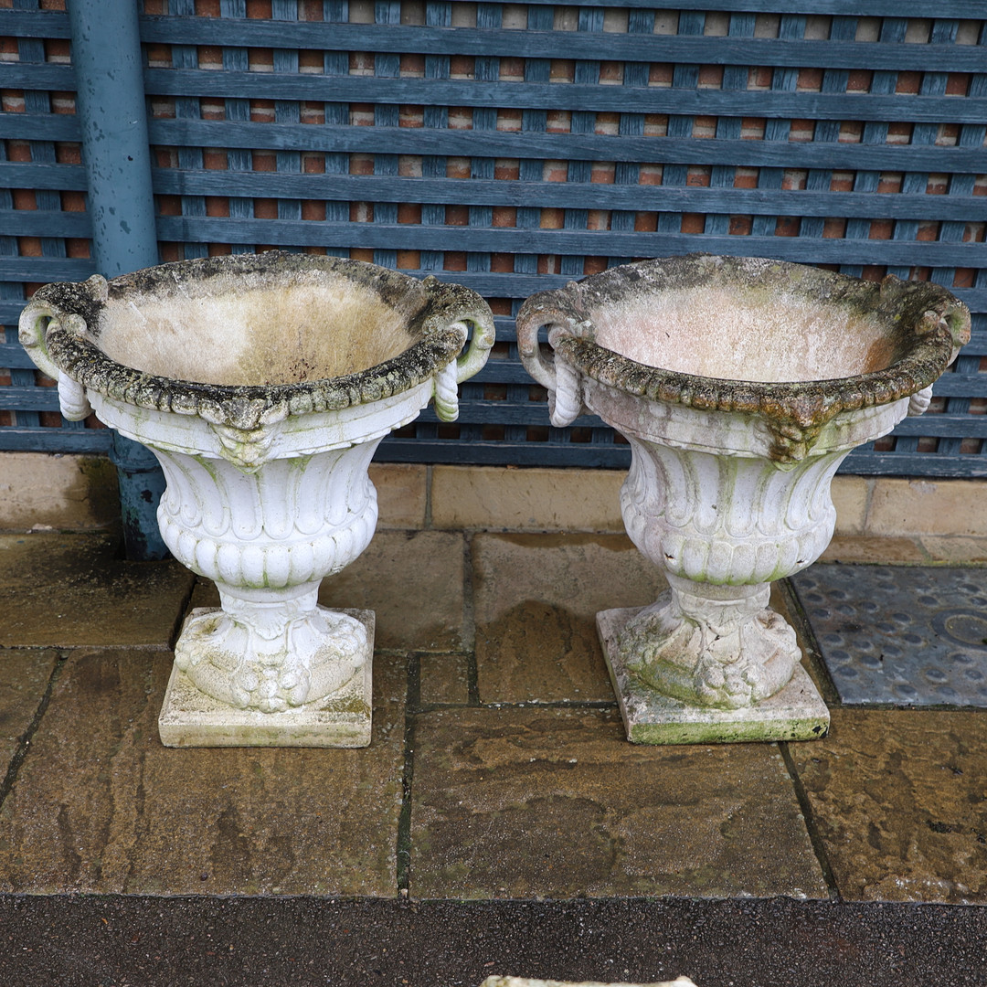 A PAIR OF PAINTED COMPOSITE MARBLE CAMPANA STYLE URNS.