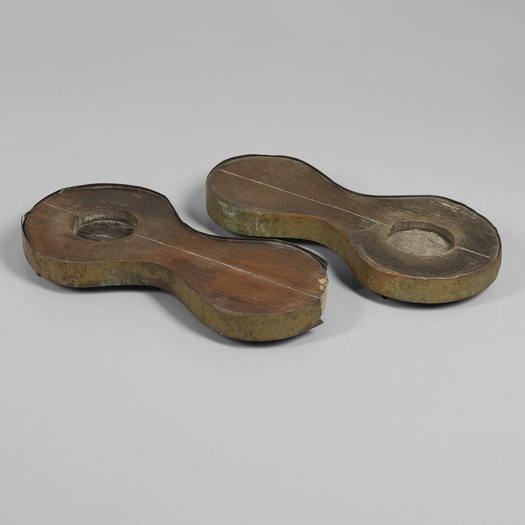 A PAIR OF EARLY 19TH CENTURY BRASS BOUND OAK TAVERN COASTERS.
