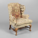 A GEORGE II STYLE WALNUT WING ARMCHAIR.