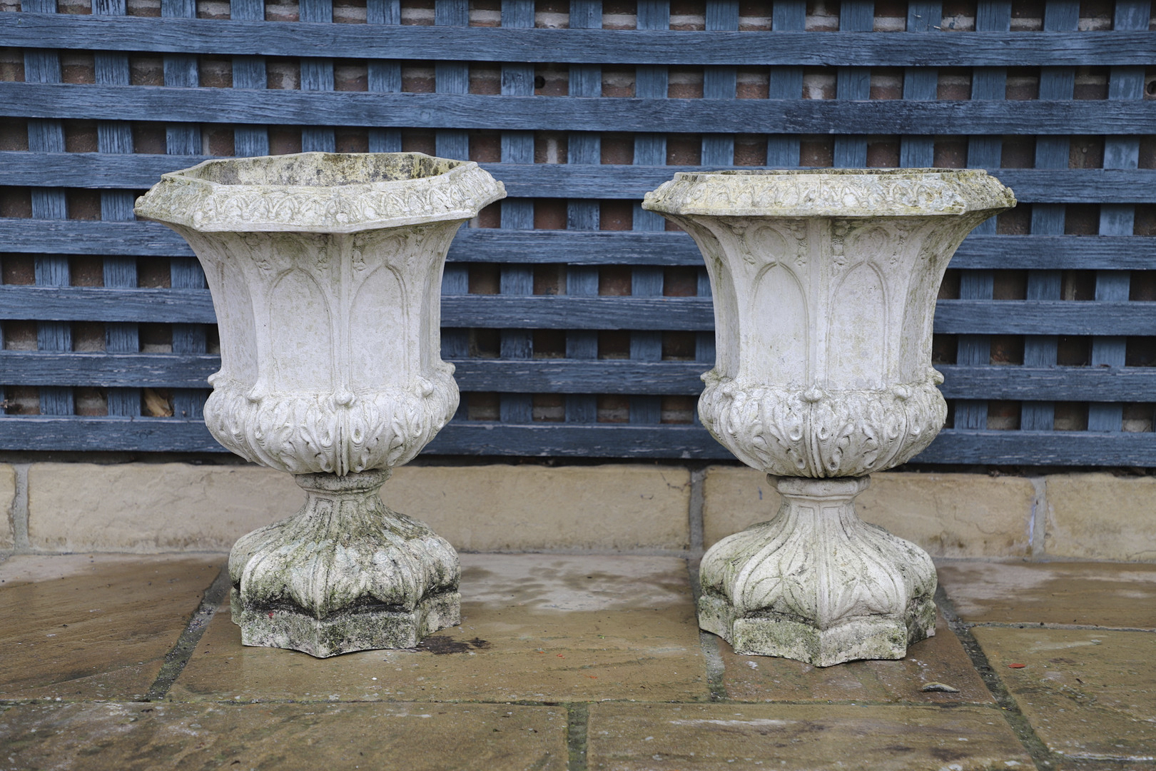 A PAIR OF FRENCH PAINTED BUFF TERRACOTTA URNS.