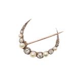 A DIAMOND AND PEARL CLOSED CRESCENT BROOCH.