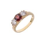A DIAMOND AND SPINEL THREE STONE RING.