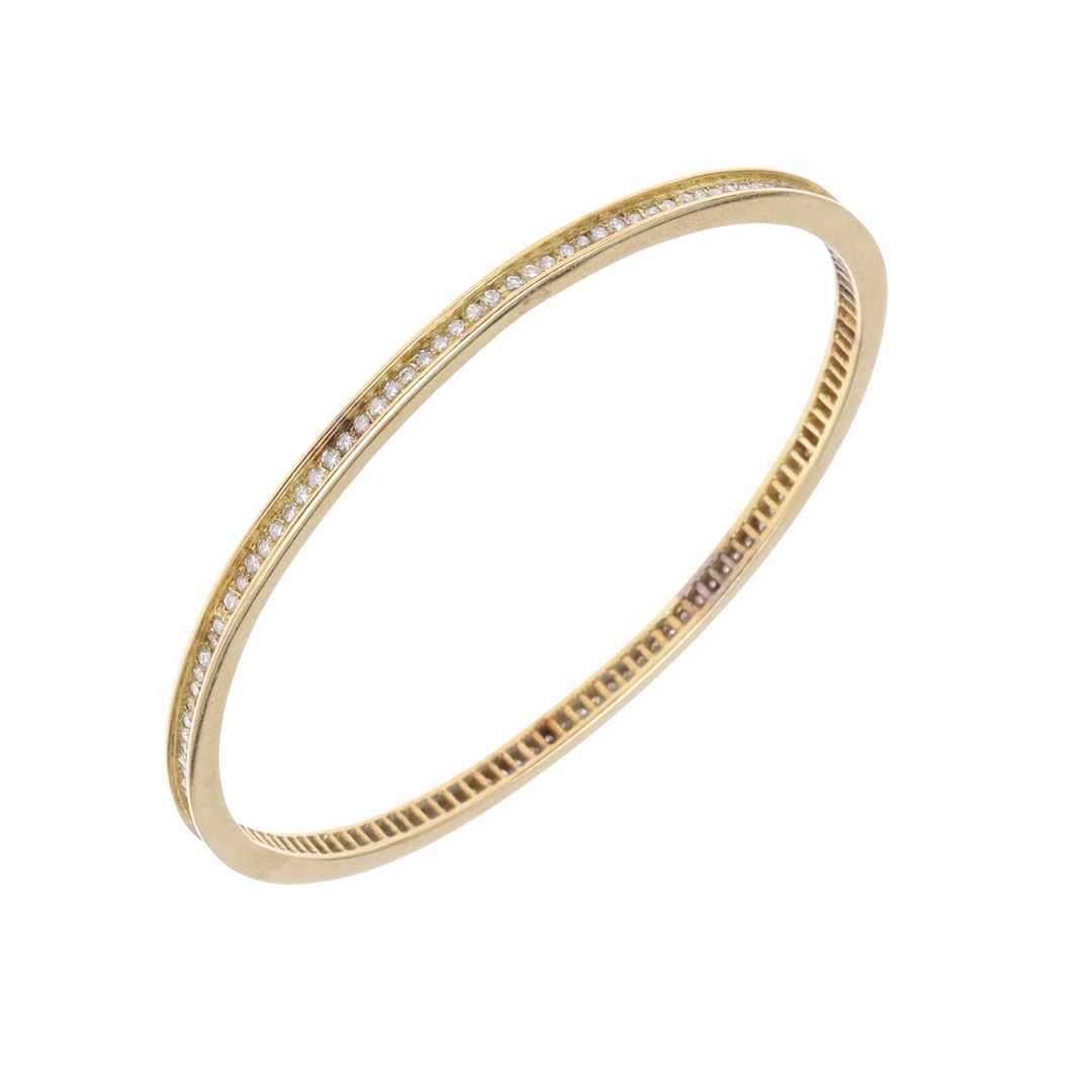 A DIAMOND AND GOLD BANGLE.