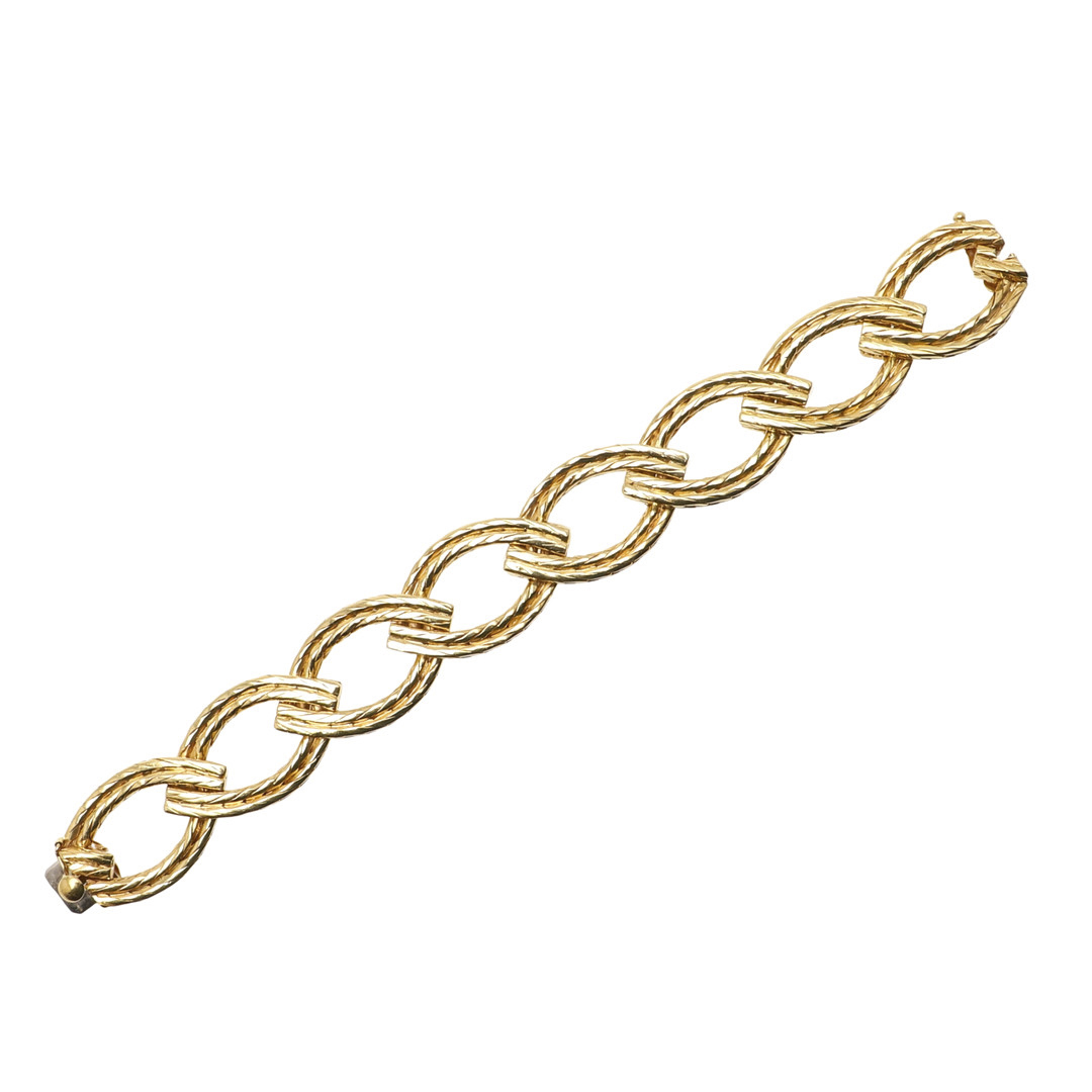 AN 18CT GOLD BRACELET BY CARTIER.