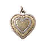 A 9CT GOLD AND SILVER HEART SHAPED PENDANT BY GUCCI.