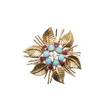 A DIAMOND, RUBY AND TURQUOISE SET FLOWERHEAD BROOCH BY CHAUMET.