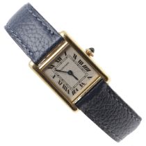 A LADY'S 18CT GOLD TANK WRISTWATCH BY CARTIER.