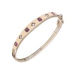 A 15CT GOLD, RUBY AND DIAMOND HALF HINGED BANGLE.