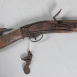 A FLINTLOCK LONG GUN IN RELIC CONDITION AND SIMILAR SWORD.