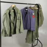 AN AMERICAN ARMY M65 FIELD COAT AND OTHERS.