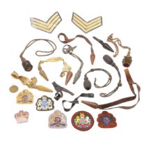 A COLLECTION OF SWORD KNOTS AND MILITARY BADGES.