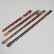 A COLLECTION OF FOUR BROWN LEATHER SERVICE SCABBARDS.