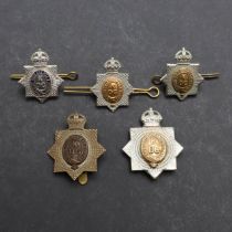 A FINE KING'S DRAGOON GUARDS OFFICERS SMALL SILVER BADGE AND A SIMILAR OTHER RANKS SET.