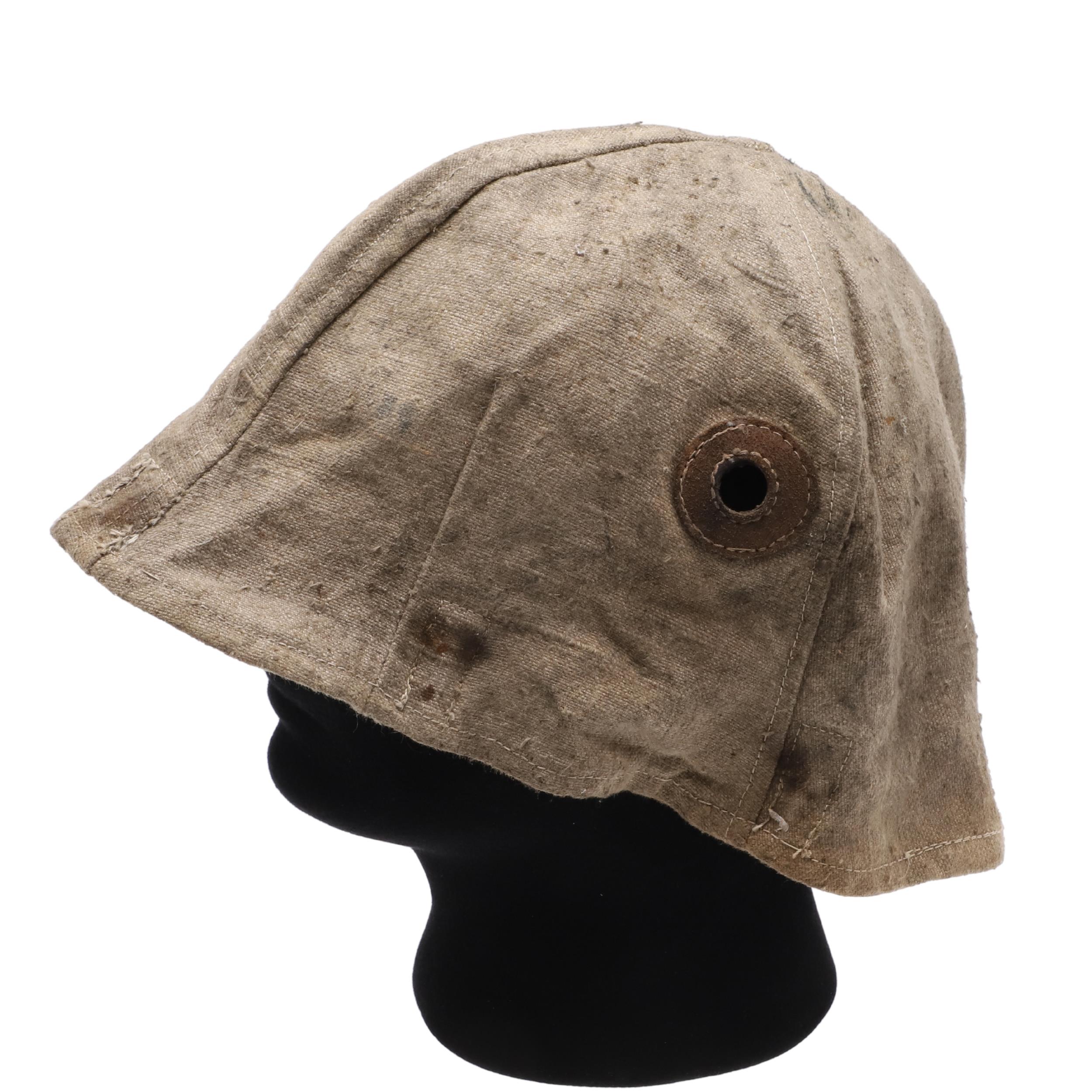 A FIRST WORLD WAR GERMAN STEEL HELMET CLOTH COVER.