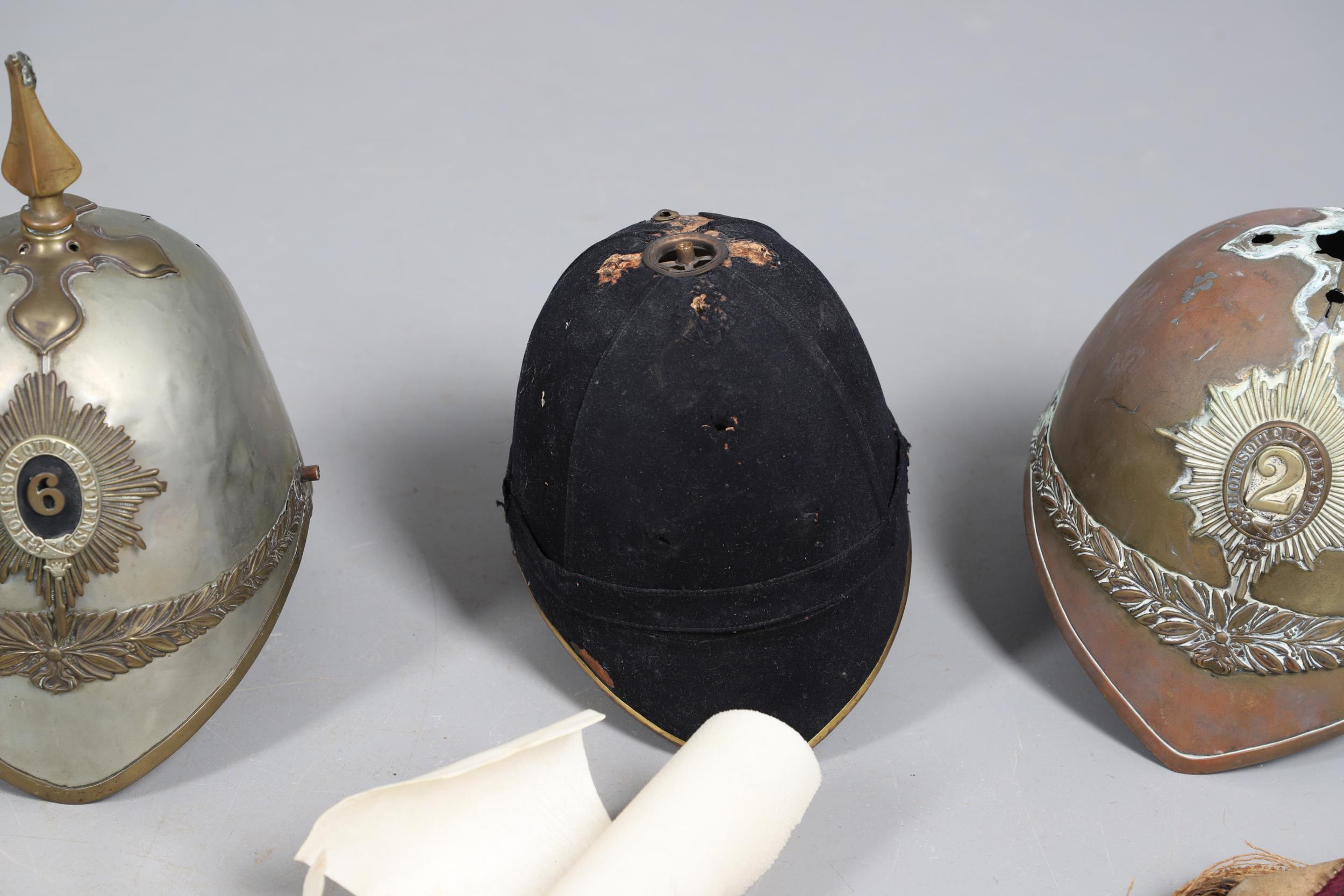 A COLLECTION OF VICTORIAN AND LATER HELMETS AND PARTS TO INCLUDE 1871 PATTERN SHELLS. - Image 5 of 19