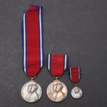TWO GEORGE V 1935 JUBILEE MEDALS AND SIMILAR MINIATURE.