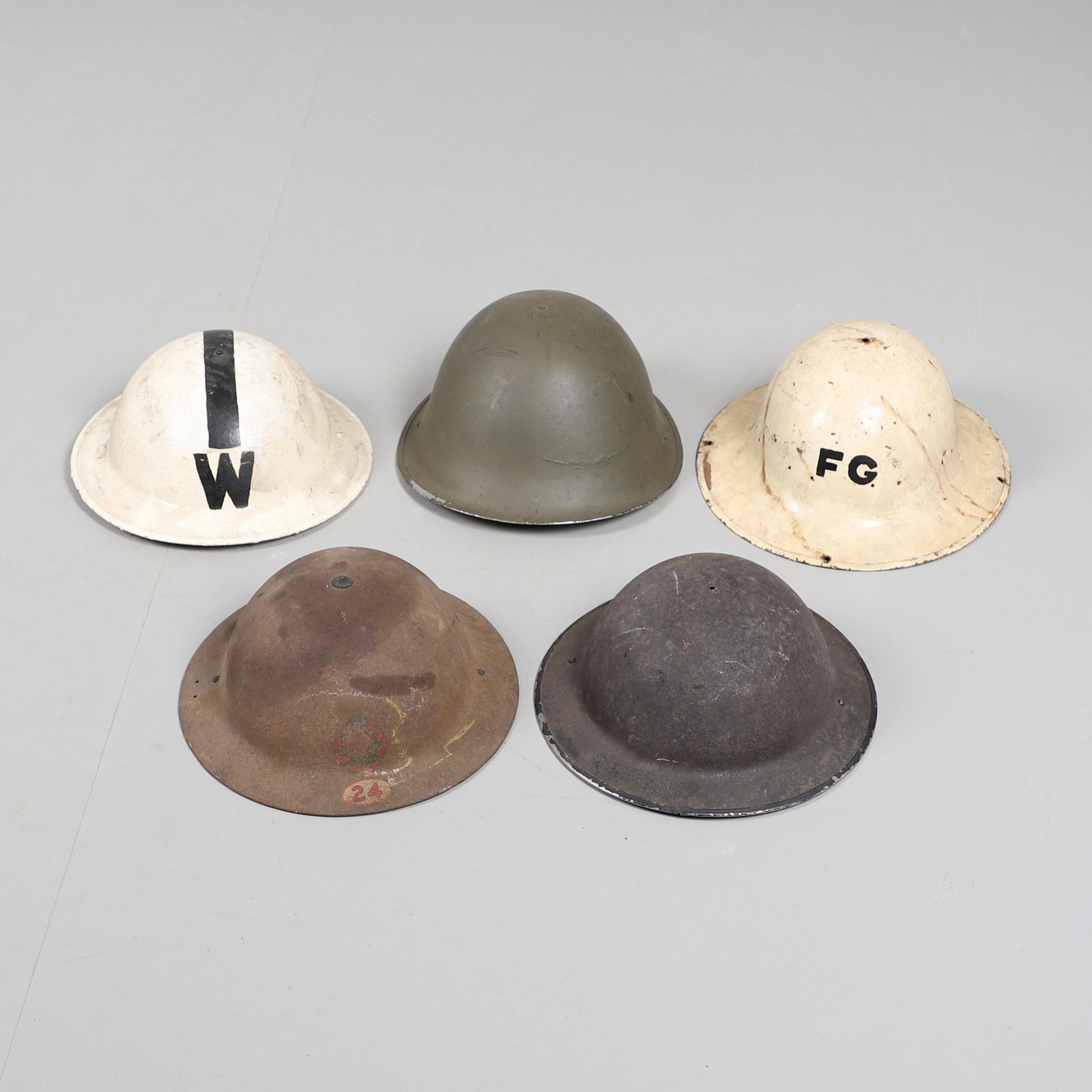 A COLLECTION OF SECOND WORLD WAR HOME FRONT HELMETS.