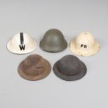 A COLLECTION OF SECOND WORLD WAR HOME FRONT HELMETS.