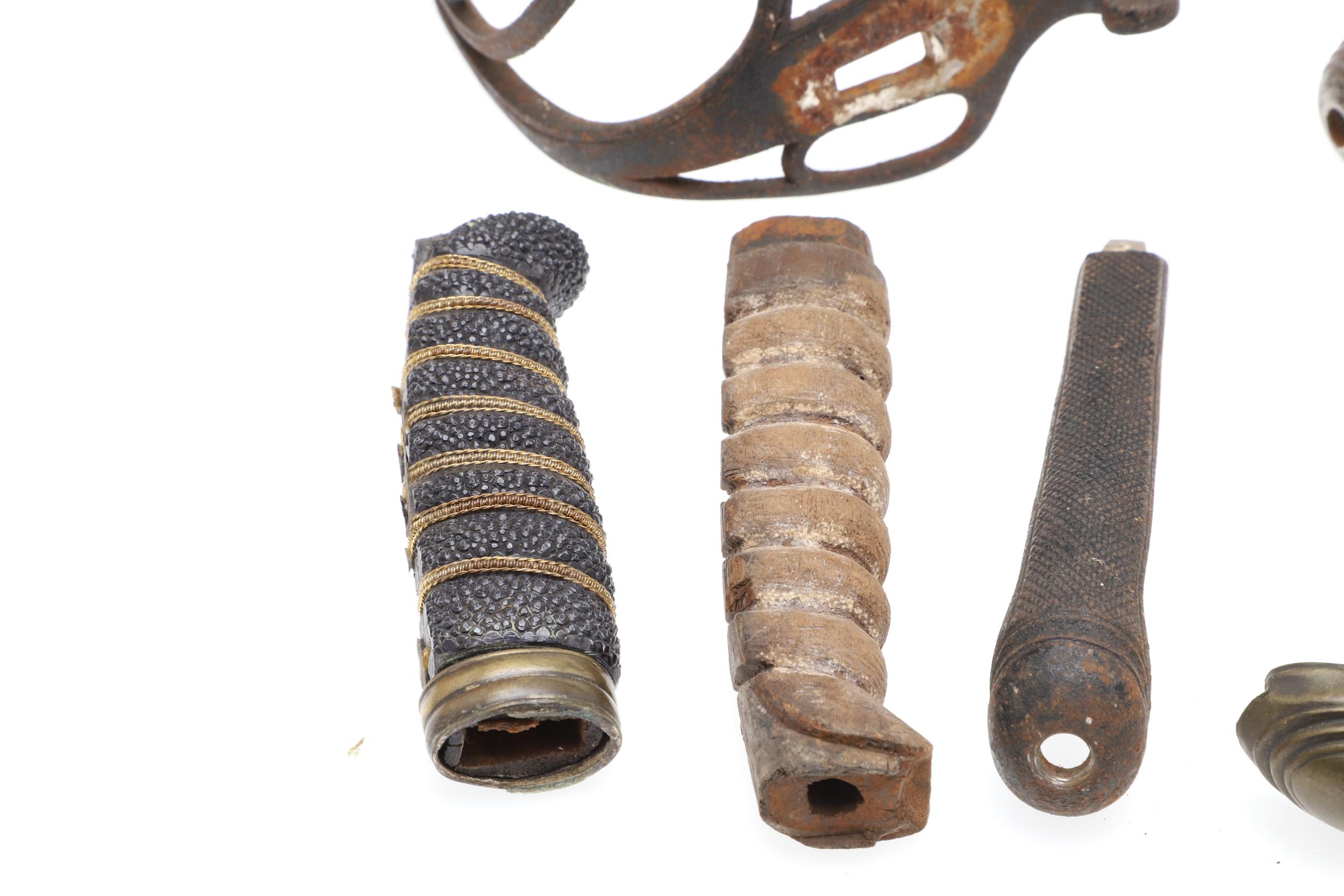 A COLLECTION OF SWORD FITTINGS TO INCLUDE GRIPS, GUARDS AND OTHERS. - Image 9 of 12