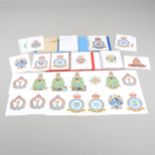 A LARGE COLELCTION OF ARTWORK OF MILITARY CRESTS. IN FOUR ALBUMS AND MANY LOOSE.