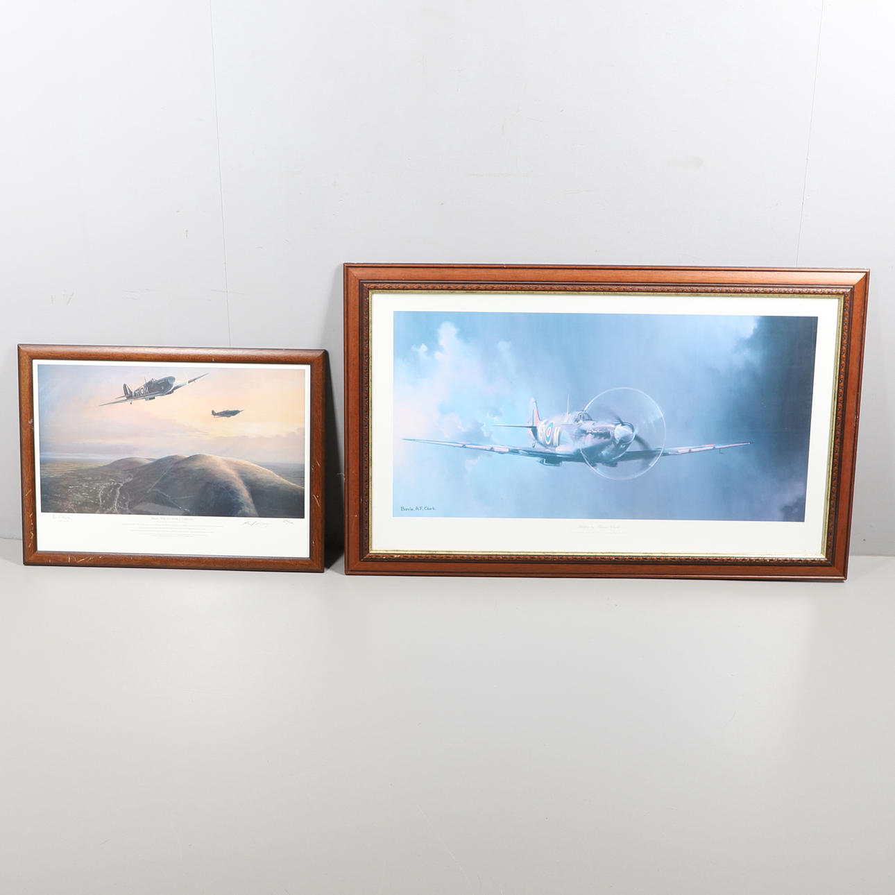 A LARGE COLOUR PRINT OF A SPITFIRE BY BARRIE CLARK, AND A SIMILAR LIMITED EDITION PRINT.