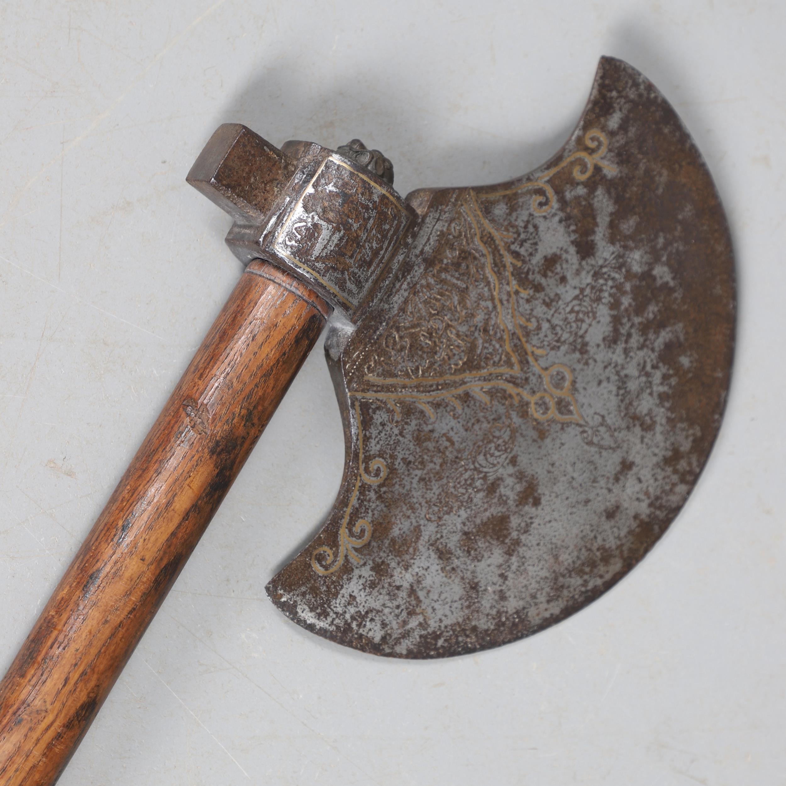 A SUBSTANTIAL PERSIAN OR OTTOMAN TWO HANDLED AXE.