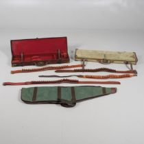 A LEATHER SHOTGUN CASE AND OTHER GUN CASES.