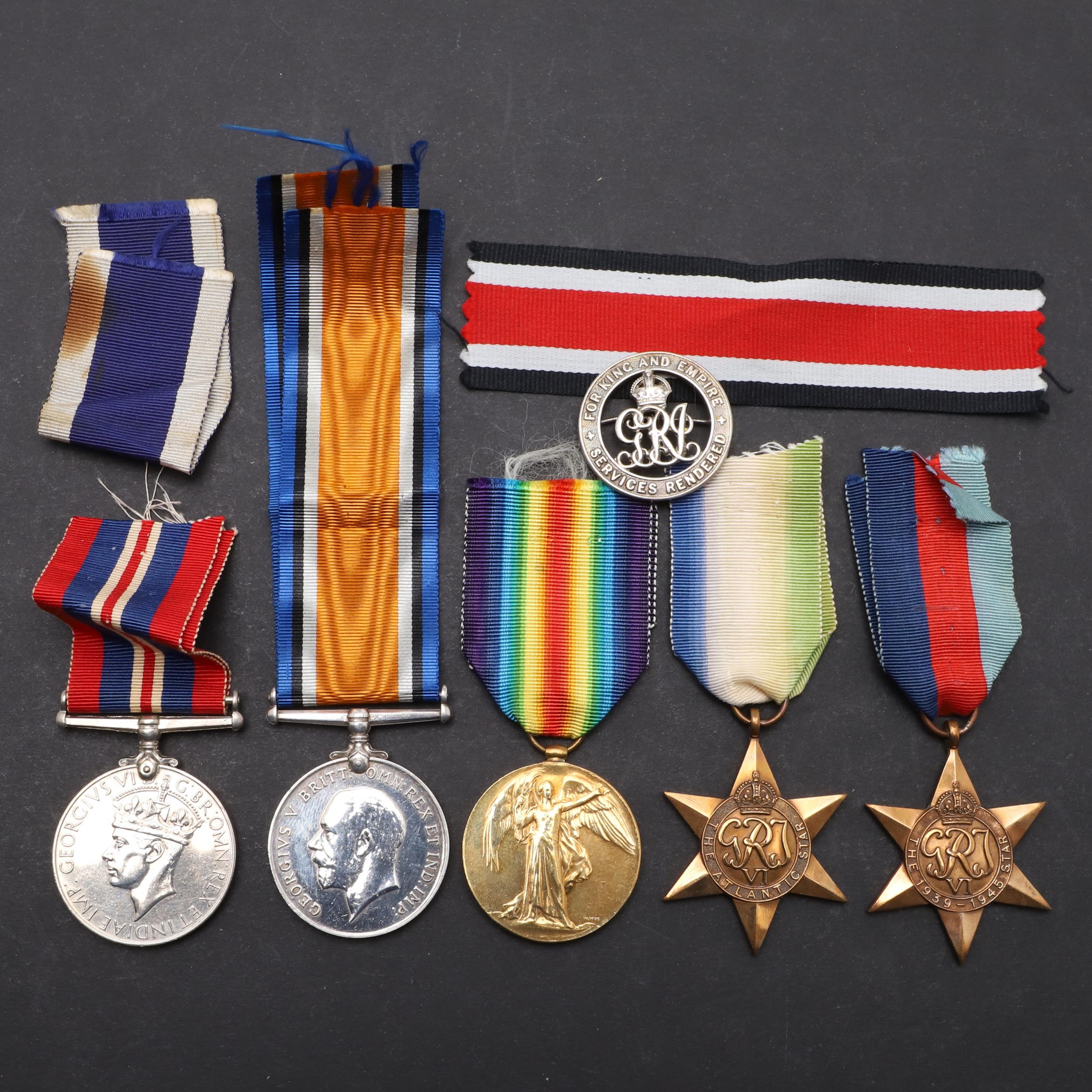 A FIRST WORLD WAR SILVER WAR BADGE AND A SMALL COLLECTION OF MEDALS.