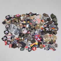 AN EXTENSIVE COLLECTION OF ARMY AND AIR FORCE UNIFORM PATCHES AND RANK INSIGNIA.