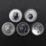 A COLLECTION OF FIVE ONE OUNCE SILVER BRITANNIA COINS. WITH GILT DETAIL. 2002 AND LATER.