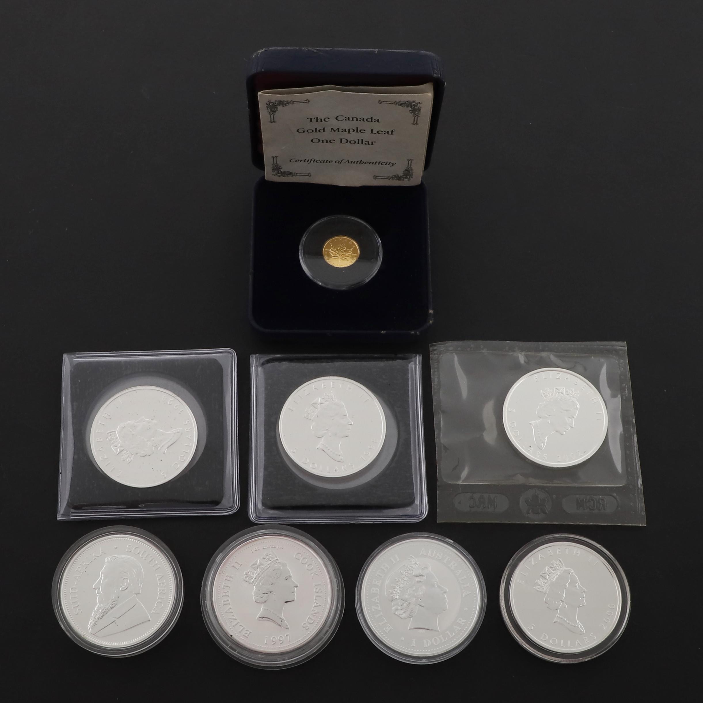 A CANADIAN GOLD MAPLE ONE DOLLAR AND OTHER SILVER ISSUES.