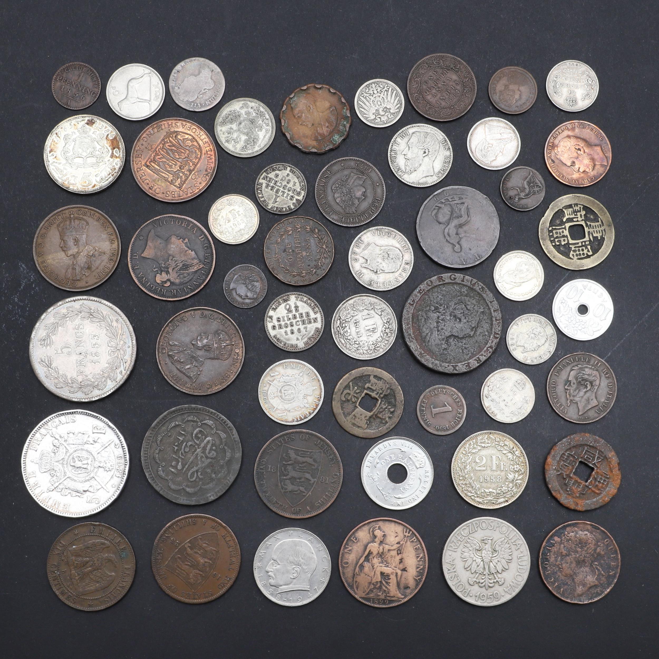 A COLLECTION OF WORLD COINS INCLUDING A NAPOLEON III 5 FRANC COIN.