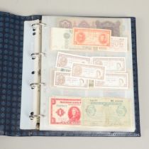 AN ALBUM OF OVER 150 WORLD BANK NOTES TO INCLUDE INDONESIA, IRAQ, CAMBODIA, ISRAEL AND OTHER COUNTRI