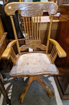 A 20th century light oak revolving office style chair.