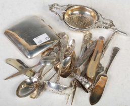 A collection of silver to include a Birmingham silver tea strainer, Birmingham silver concave