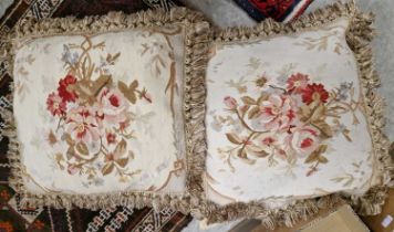 A pair of Aubusson style cushions with floral decoration.