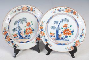 A pair of Chinese porcelain Imari plates, Qing Dynasty, decorated with gardens of rock work, peony