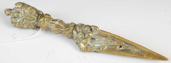 An antique Tibetan brass ritual knife/ dagger, with triple edged blade entwined with serpents and