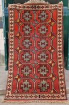 A Persian Ghoochan rug, the rectangular madder ground decorated with twelve octagonal-shaped