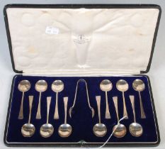 A cased set of twelve Sheffield silver coffee spoons and sugar tongs, engraved with initial 'H'.