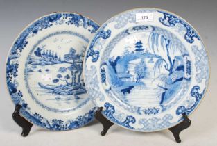 Two Chinese blue and white porcelain circular dishes, Qing Dynasty, one decorated with pavilion in a