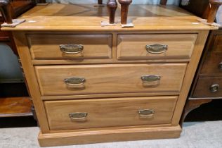 An antique pine chest of two short over two long graduated drawers.