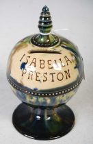 A 19th century Scottish pottery money bank, inscribed 'Isabella Preston' with blue, green and