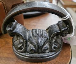 An antique miniature cast iron iron.