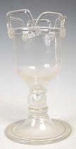 A continental antique glass goblet, the bowl with applied trailed line detail, the knop with three